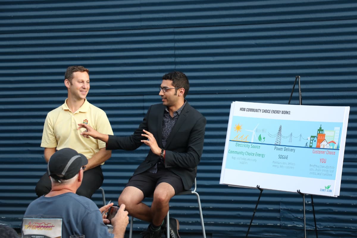 Photo of Neil Gerber and Matthew Vasilakis educating Solana Beach residents about energy options