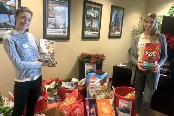 Sullivan Community Developers similing next to dontated pet supplies