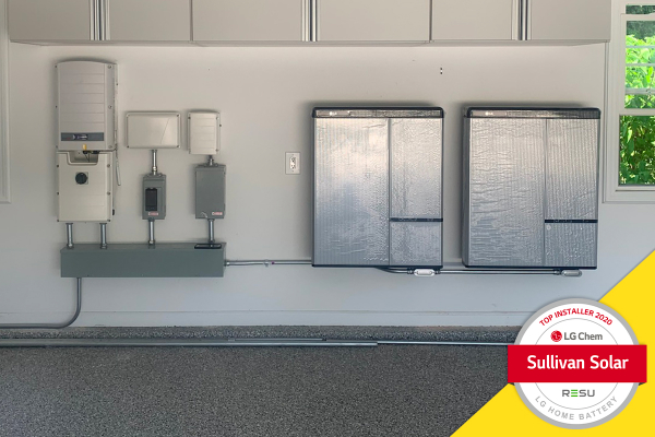 Photo of two LG Chem batteries mounted to residential garage wall