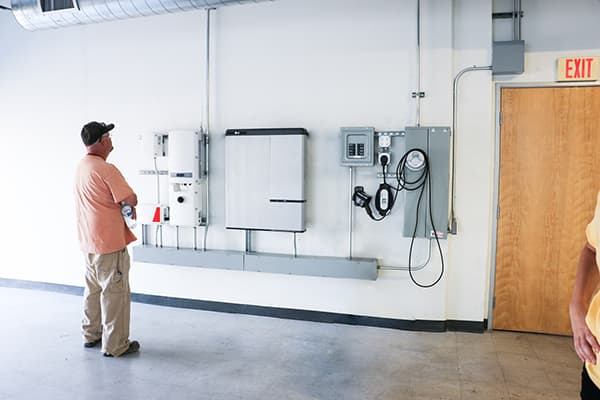 Man Evaluating the Installation of a Residential Solar Battery System
