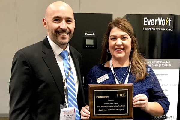 Panasonic and Sullivan employees smiling and showing award