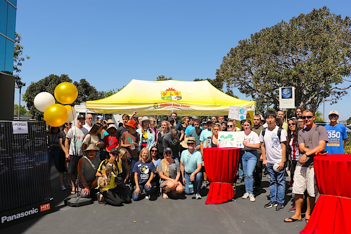Group photo of walkout attendees in front Sullivan Solar Power's San Diego office