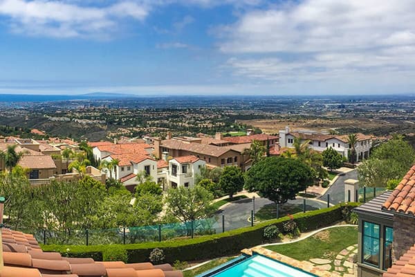 Photo of beautiful Orange County from elevation over Spanish tile rooftop looking toward the coastline